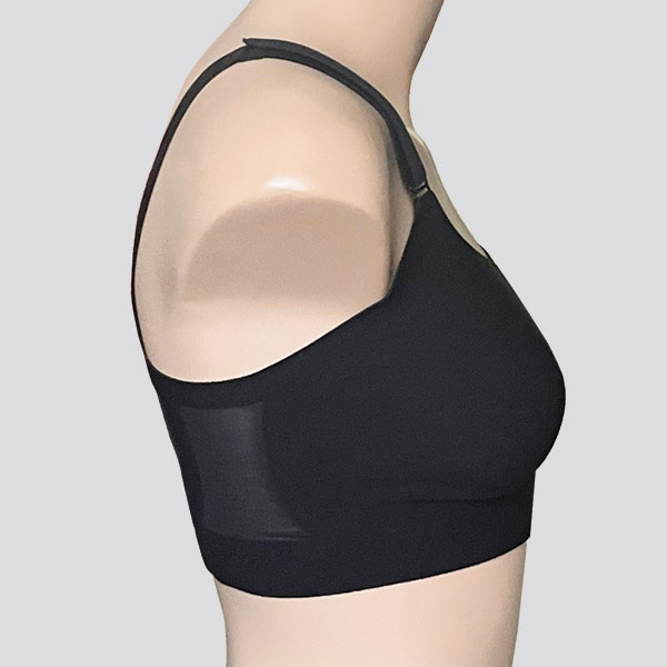 Side view of the Amoena Jackie front fastening padded wireless bra showing higher tapering underarm band and mesh panel.